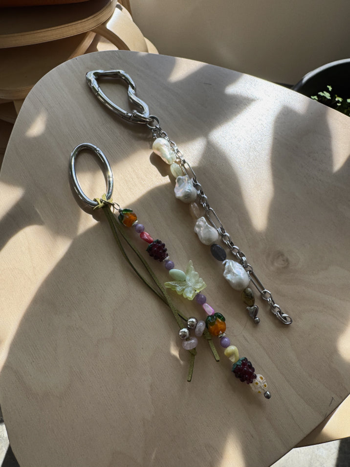 Decorative keychain with beads on a wooden surface